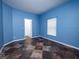 Bright blue bedroom featuring tiled floors, a window with blinds and a closet for storage space at 12805 Sw 64Th Ln, Ocala, FL 34481