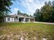 One-story house with gray siding, a brown garage door, and a lush green lawn at 12805 Sw 64Th Ln, Ocala, FL 34481