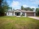 Single-story home with gray siding and a brown garage door at 12805 Sw 64Th Ln, Ocala, FL 34481
