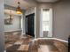 Open foyer with beautiful tile flooring and a view into the dining room at 12805 Sw 64Th Ln, Ocala, FL 34481