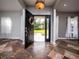 Open foyer with beautiful tile flooring and a view of the front yard at 12805 Sw 64Th Ln, Ocala, FL 34481