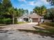 Charming home featuring a well-manicured lawn, mature palm trees and a two-car garage at 12805 Sw 64Th Ln, Ocala, FL 34481
