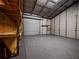 Garage interior with roll up door, shelves and workbench at 12805 Sw 64Th Ln, Ocala, FL 34481