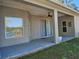 Inviting covered patio with ceiling fan offering a tranquil outdoor space for relaxation at 12805 Sw 64Th Ln, Ocala, FL 34481