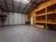 Spacious metal storage building interior with built-in shelving and concrete flooring at 12805 Sw 64Th Ln, Ocala, FL 34481