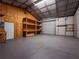 Spacious metal storage building interior with built-in shelving and concrete flooring at 12805 Sw 64Th Ln, Ocala, FL 34481
