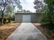 Exterior view of the metal storage building with a wide concrete driveway at 12805 Sw 64Th Ln, Ocala, FL 34481
