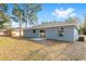 Backyard view of the home showing the yard and patio at 15282 Sw 27 Ln, Ocala, FL 34481
