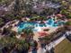Aerial view of community pool with surrounding palm trees and lounge areas at 6014 Sw 93Rd Cir, Ocala, FL 34481