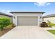 Attached garage with light gray door at 6014 Sw 93Rd Cir, Ocala, FL 34481