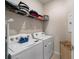 Convenient laundry room with washer, dryer, and shelving at 6014 Sw 93Rd Cir, Ocala, FL 34481