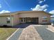 Backyard featuring a brick paver patio with gravel borders leading to the house at 10923 Sw 38Th Ave, Ocala, FL 34476