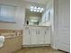 A bathroom features a vanity, a bathtub, and a mirrored cabinet with dark hardware at 10923 Sw 38Th Ave, Ocala, FL 34476
