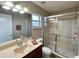 Bathroom featuring a vanity with a sink, a toilet, and a shower with glass sliding doors at 10923 Sw 38Th Ave, Ocala, FL 34476