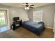 Bedroom with carpet, neutral walls, ceiling fan, and door leading to porch at 10923 Sw 38Th Ave, Ocala, FL 34476