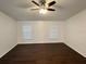 Bright bedroom with wood floors, neutral walls, and two windows providing natural light at 10923 Sw 38Th Ave, Ocala, FL 34476