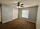 A minimalist bedroom with grey walls, brown carpet, and a white closet with bi-fold doors at 10923 Sw 38Th Ave, Ocala, FL 34476