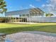 Large backyard carport with white fence and spacious lawn, great for outdoor activities at 10923 Sw 38Th Ave, Ocala, FL 34476