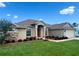 Charming single-story home with manicured lawn, stone accents, and arched entryway at 10923 Sw 38Th Ave, Ocala, FL 34476