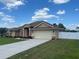 Attractive home with a spacious driveway, manicured lawn, and white vinyl privacy fence at 10923 Sw 38Th Ave, Ocala, FL 34476