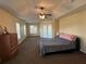 Large main bedroom featuring neutral paint, tray ceilings, and walk out patio at 10923 Sw 38Th Ave, Ocala, FL 34476