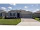 Charming single-story home with a two car garage, stone accents, and well-manicured front lawn at 4111 Nw 48Th Terrace Rd, Ocala, FL 34482