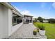 Back patio with paved area overlooking expansive lawn and neighborhood views at 6042 Topsail Rd, Lady Lake, FL 32159