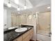 Bathroom featuring a double vanity, granite countertops, decorative stained glass, and a shower-tub combination at 6042 Topsail Rd, Lady Lake, FL 32159