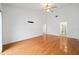 Spacious bedroom with hardwood floors, high ceilings, and multiple access points and doorways at 6042 Topsail Rd, Lady Lake, FL 32159