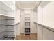 Bright white walk-in closet with custom shelving and metal storage baskets at 6042 Topsail Rd, Lady Lake, FL 32159