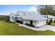 Beautiful home with lush landscaping, a light tile roof, and a paver driveway at 6042 Topsail Rd, Lady Lake, FL 32159