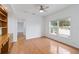 Office space features hardwood floors, custom built-in shelving, a large window, and an open design at 6042 Topsail Rd, Lady Lake, FL 32159