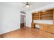 Well-lit office with hardwood floors, custom built-in desk and shelving, and a neutral color scheme at 6042 Topsail Rd, Lady Lake, FL 32159