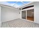 Enclosed back patio with stone pavers and a sliding glass door leading inside at 6042 Topsail Rd, Lady Lake, FL 32159