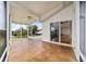 Large screened porch with ceiling fan and sliding glass door at 6042 Topsail Rd, Lady Lake, FL 32159