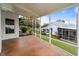Spacious screened porch providing views of manicured yard and the neighborhood at 6042 Topsail Rd, Lady Lake, FL 32159