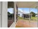 Relaxing screened porch overlooking the lush backyard and neighboring home at 6042 Topsail Rd, Lady Lake, FL 32159