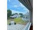 The window view shows a well maintained lawn and a beautiful home in a distance at 6042 Topsail Rd, Lady Lake, FL 32159
