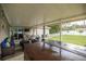 Covered back patio area with an outdoor kitchen overlooking a large backyard at 10291 Se 42Nd Ter, Belleview, FL 34420