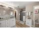 Tastefully designed bathroom featuring a frameless shower and dual vanities with granite countertops at 10291 Se 42Nd Ter, Belleview, FL 34420