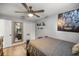 Cozy bedroom with a ceiling fan, closet, and large mirror for getting ready in the morning at 10291 Se 42Nd Ter, Belleview, FL 34420