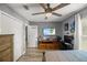 Comfortable bedroom featuring a ceiling fan, closet, and entertainment center for gaming and watching TV at 10291 Se 42Nd Ter, Belleview, FL 34420