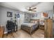 Bedroom featuring a ceiling fan, desk, and comfortable bed, perfect for relaxing or getting work done at 10291 Se 42Nd Ter, Belleview, FL 34420