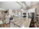This spacious kitchen boasts white cabinets, stone countertops, stainless steel appliances, and island seating at 10291 Se 42Nd Ter, Belleview, FL 34420