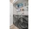Convenient laundry room with shelving for storage above a modern washer and dryer set at 10291 Se 42Nd Ter, Belleview, FL 34420