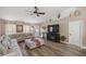 Cozy living area with large sectional sofa, fireplace, and ceiling fan at 10291 Se 42Nd Ter, Belleview, FL 34420
