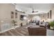 Comfortable living room boasting a vaulted ceiling, a ceiling fan and wood-look flooring at 10291 Se 42Nd Ter, Belleview, FL 34420