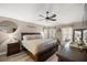 Spacious main bedroom with ceiling fan, sitting area, and neutral decor at 10291 Se 42Nd Ter, Belleview, FL 34420