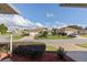 A view of a charming, light-colored single-Gathering home and the street of the community at 17430 Se 110Th Ter, Summerfield, FL 34491