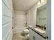 Bright bathroom featuring a shower-tub combo, granite counters and neutral flooring at 8949 Se 159Th Ln, Summerfield, FL 34491